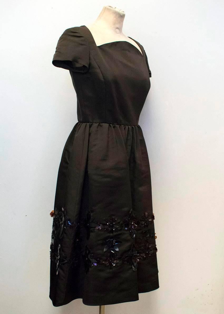 Oscar de la Renta dark brown, silk, mid-length dress with a fitted body and full skirt. It features capped sleeves, side pockets and plastic and beaded floral embellishments towards the hem. 

Please note that there is a matching jacket for this