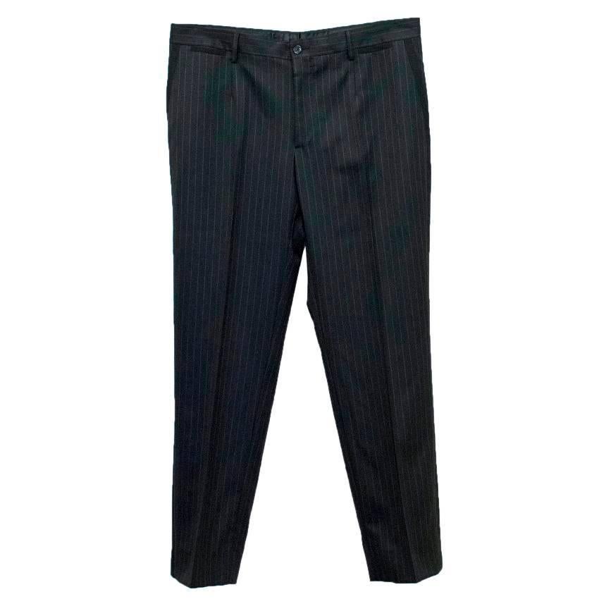 Dolce & Gabbana black, silk and wool blend, pinstripe, medium weight, two piece suit. The jacket is fully lined and features a notch lapel, single breast, three exterior pockets, three interior pockets, and a single vent. The trousers feature four