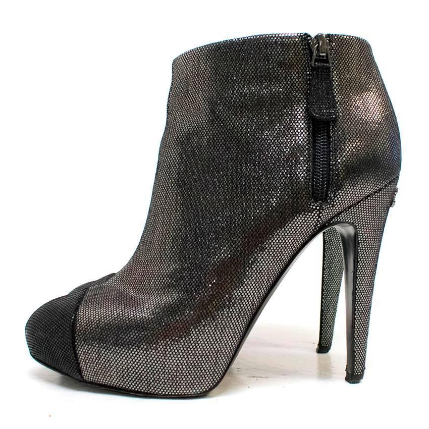 Chanel cap-toe metallic leather high-heeled ankle boots with two zips one on either side and an embellished brand logo on the heel. 

Conditions Details : There are signs of wear on the soles and the heels, otherwise the shoes are in good