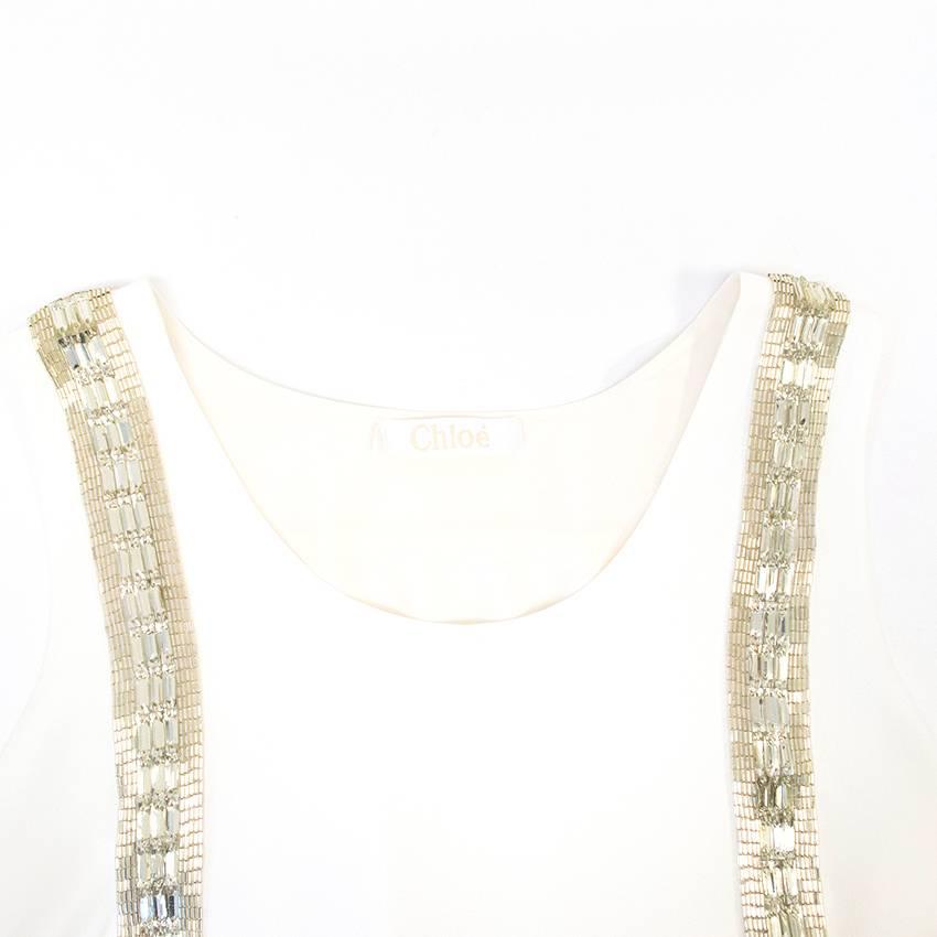 Chloe White Beaded Arrow Top. Never worn, without tags 10/10. Perfect condition. Made in France. Belongs to Caroline Stanbury from 'Ladies of London'.

Approximate measurements: 

Shoulders: 33cm 
Length:39.5cm 
Bust: 46cm

UK size 8
US size 4



