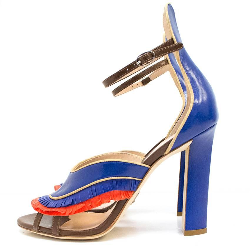 High-heeled sandals with blue and orange leather fringe detail and brown ankle straps.

Never worn. Perfect condition. Comes with original box.
Perfect condition 10/10.

Height of heel: 11cm
Width of foot: 8.5cm
Size: 39 IT 
Size: 6 UK
Size: 9 US
