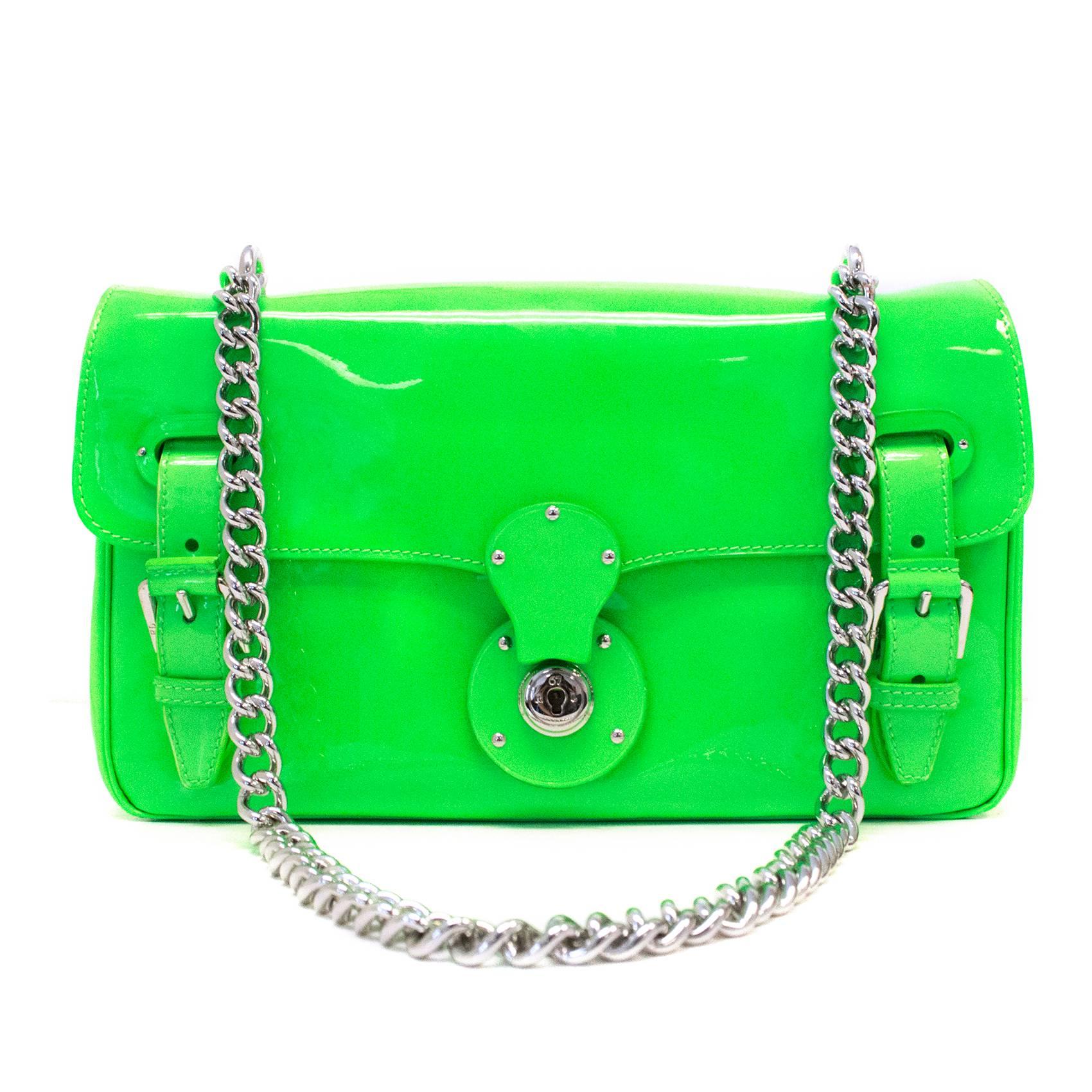 Ralph Lauren 'Ricky' shoulder bag in neon green patent lather. Silver hardware and buckle closures on front flap.
Slight colour transfer on bottom of bag and on front under flap, slight dent on underside of flap.( please see image 9 for reference).