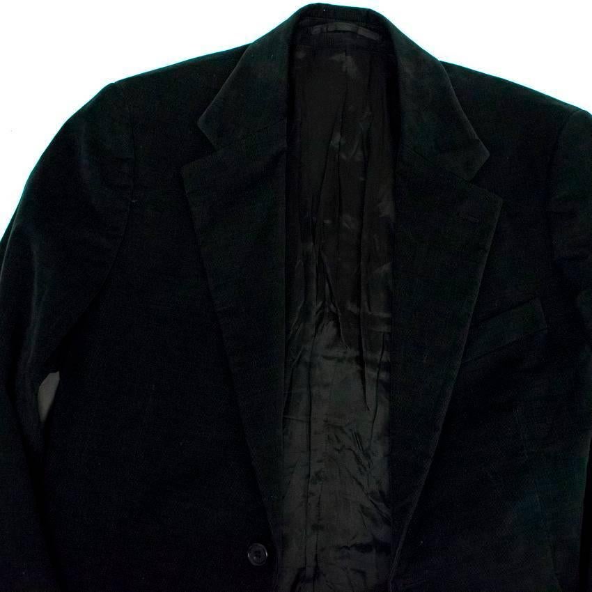 Prada dark green corduroy suit. Features a single vent, a notch lapel, is single breasted, and is fully lined. There are 2 buttons at the center and 4 non-function buttons on each sleeve at the wrists. This jacket features a flap pocket on each