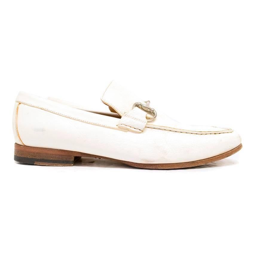 Gucci White Leather Loafers. Chic design and detailed stitching throughout. Silver Buckle Embellishment and comfortable tan leather interior.

Condition: Good despite slightly worn soles, some creasing in the leather from wear, and very minimal mark