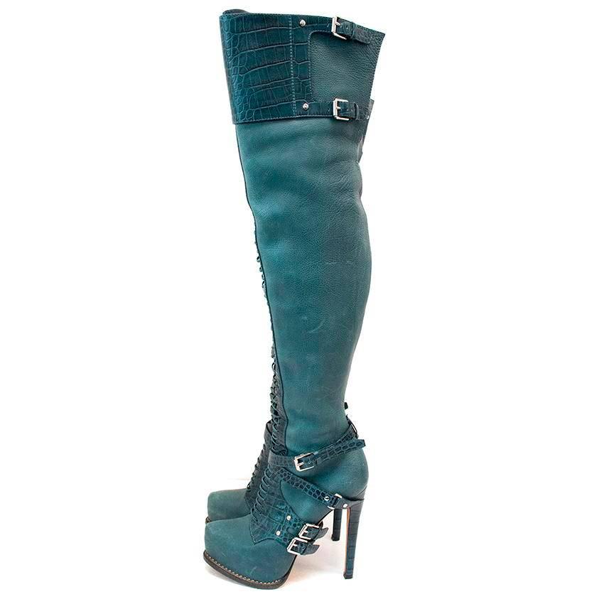 Teal leather over-the-knee heeled boots with croc inserts, buckle straps and lattice detail. Made in Italy.

Great condition, 8.5/10. There are marks on the interior and exterior leather, please see image 8 and 9 and soles show signs of
