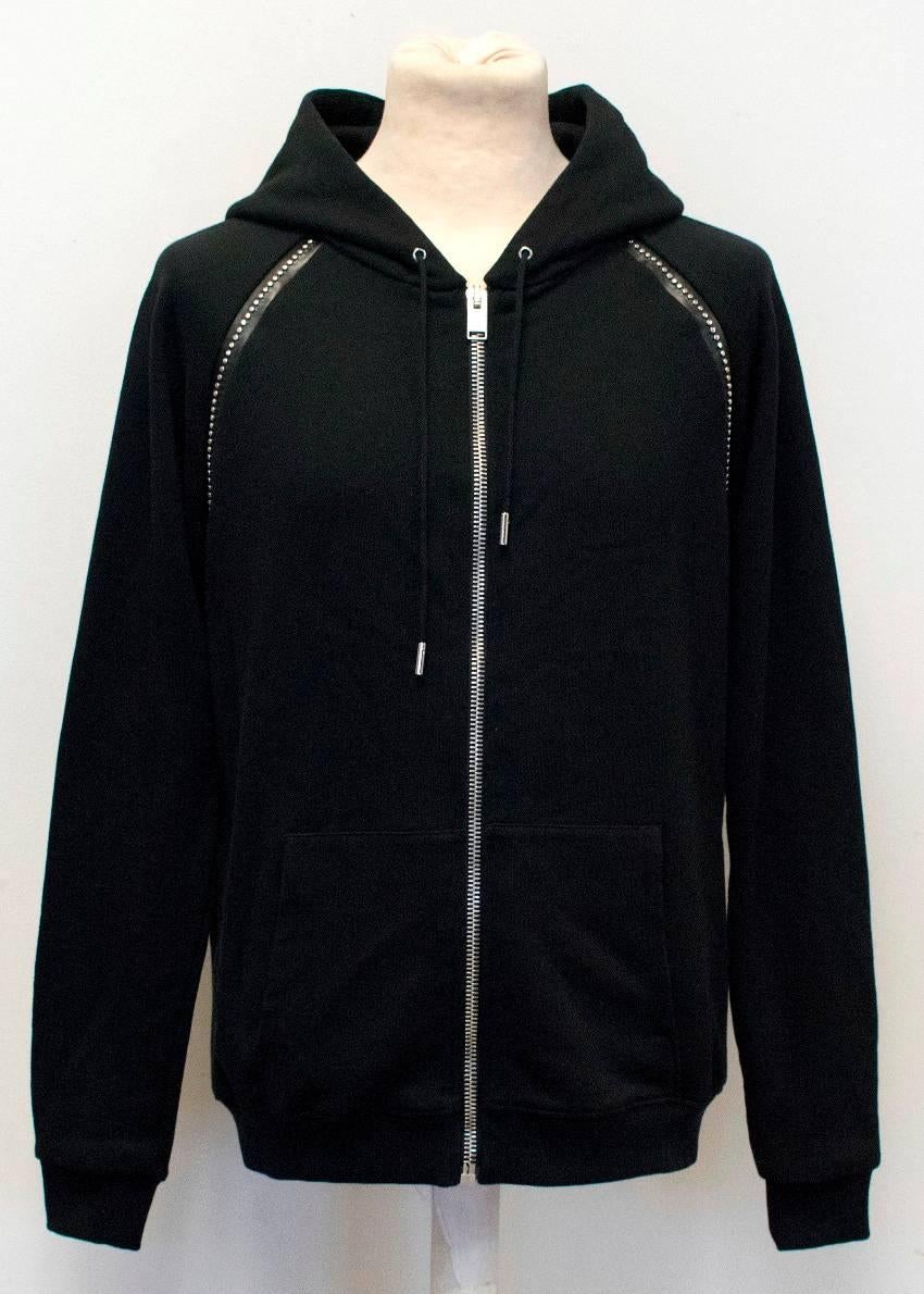 Saint Laurent cotton black long-sleeved hoodie. The hoodie has a zip and two pockets at the front, and embellishment with leather stripes and iron beads. 

Condition:10/10

Approx.
Shoulders: 50cm
Chest: 52cm
Waist: 48cm
Length: 64cm
Sleeve: