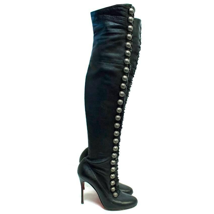 Christian Louboutin black 'Ronfifi Alta 100' buttoned boots. These boots feature buttons up the legs with elastic bands latching across. These are over the knee boots and feature a red bottom sole. 

Condition: 8.5/10 There are signs of wear to the