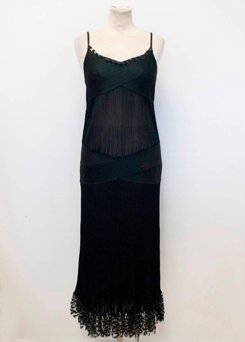 Chanel black strappy ankle length dress. The dress features a bandage design around the bust and mesh embellishments on the neckline and at the hem.

Condition: 10/10
There is no size label on the dress, but the seller is usually wearing S