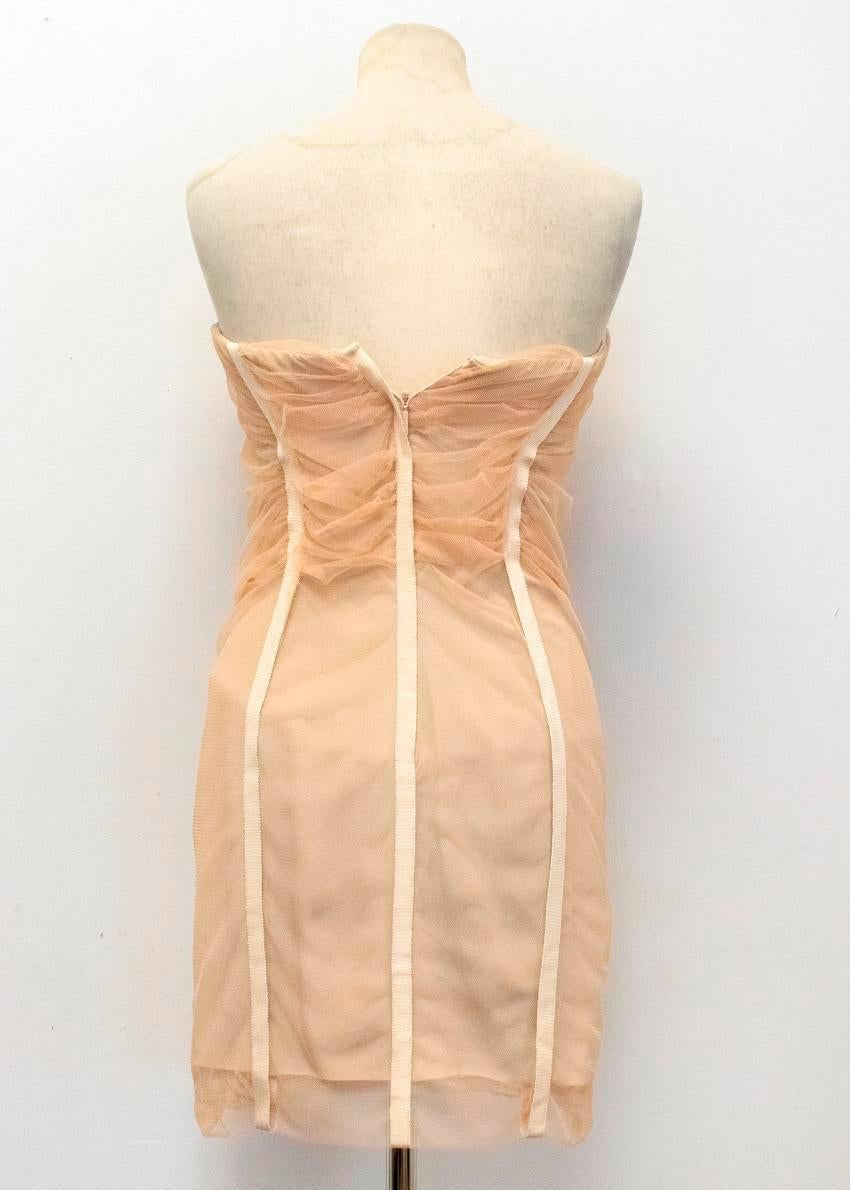 Roberto Cavalli nude pink strapless mini dress with a mesh overlay featuring rose sequins and ruffles at the front and a sweetheart neckline. Lined on the inside and features boning. Fastens at the back with a concealed zipper and a metal hook at