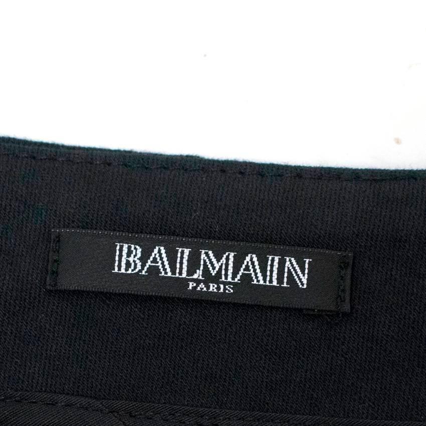 Balmain black mini skirt embellished with black and gold toned crystals in a down pointing stripe pattern. Fastens at the back with a gold toned zip.

There are a couple crystals missing on the side seam, but this is only noticeable upon close