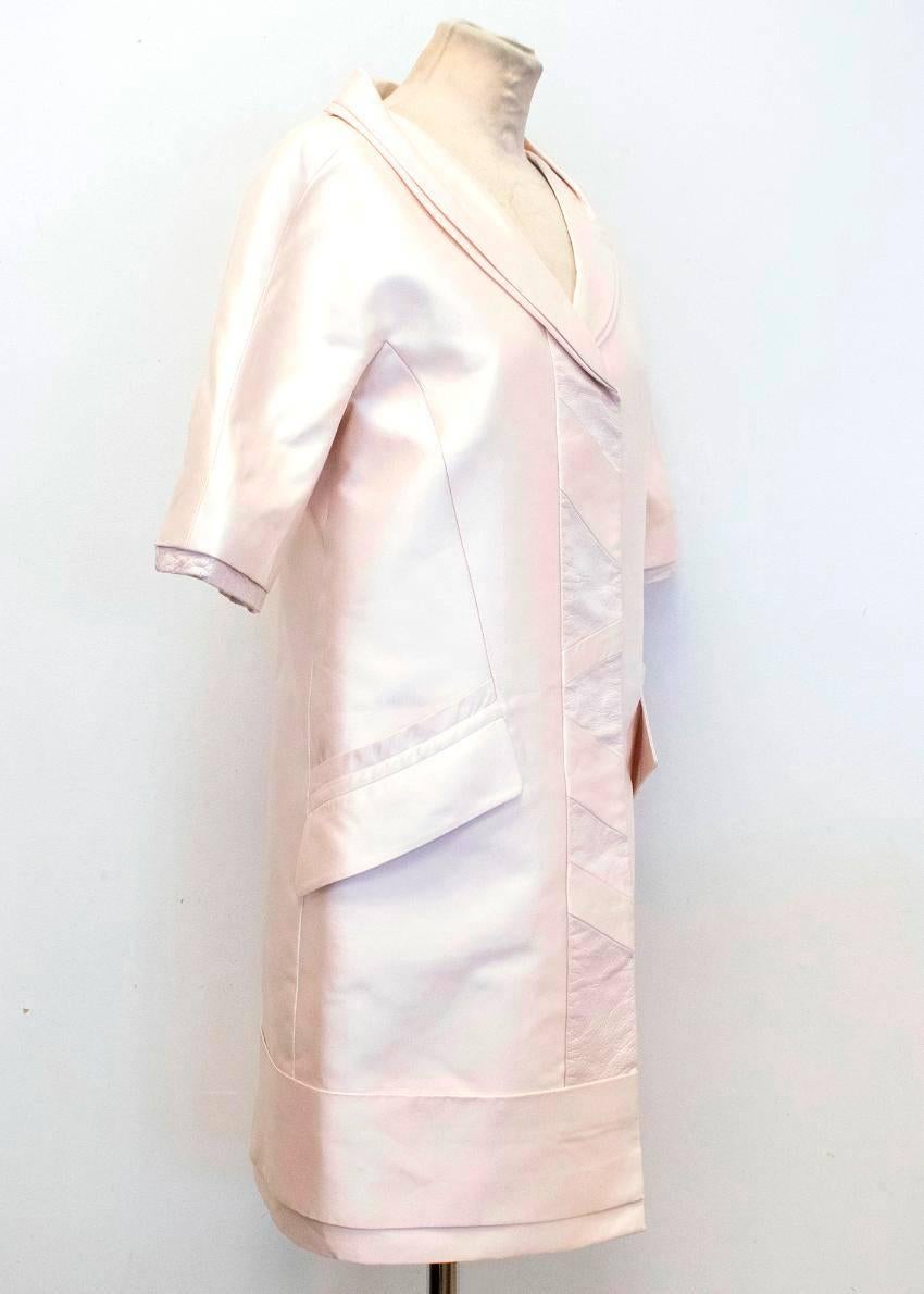 Louis Vuitton lightweight silk coat in cream with short sleeves rimmed with creased patent leather details and patent leather inserts at the front. Features a shawl lapel, four front pockets and fastens at the front with concealed pop out buttons. 
