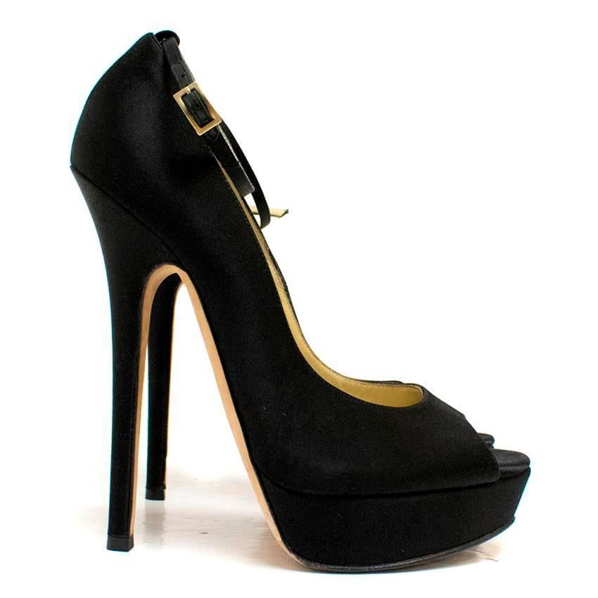 Jimmy Choo black silk high-heeled pumps on a platform with a peep toe and an ankle strap featuring a gold toned buckle. Lined with nude leather. 

There is wear to the soles and minor marks on the lining.

Condition: 9/10 

Size IT: 38
Size UK: