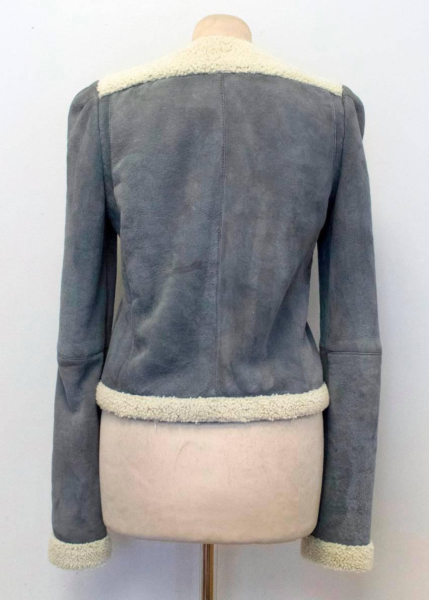 Balenciaga Leather grey suede and shearling lined jacket. This jacket features shearling along the hem, neckline, down the center, along the cuffs, and around the arm seams. There is a zipper down the center. The interior of this jacket is lined