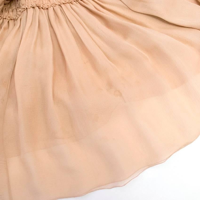 Chanel nude, silk, sleeveless dress from Autumn 2006 collection. The dress has thin shoulder straps, a ruffle skirt, zip at the back, boning on the waistline and peak-shaped back line. 

Condition: 9/10
There are couple of marks at the bottom of the
