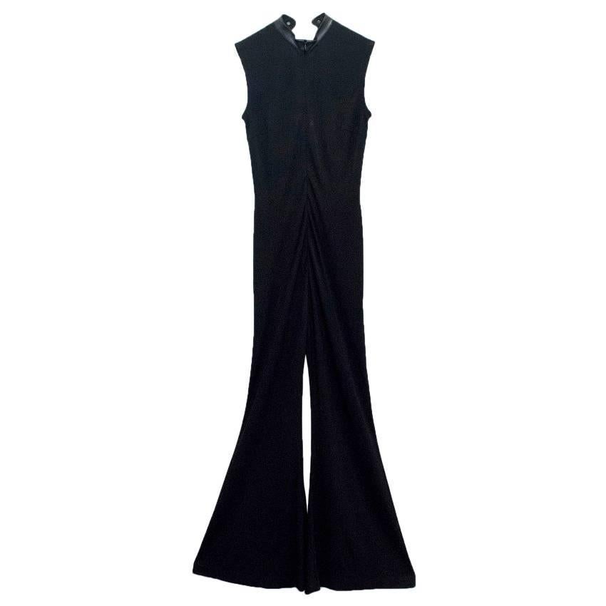 Escada black jumpsuit with flare trousers and lace up embellishment at the front. The garment features leather trim, standing collar and zip at the back.

Condition: 9.5/10

Size: XXS
Size UK: 6
Size US: 2

Measurements Approx:

Shoulders -36cm
Bust