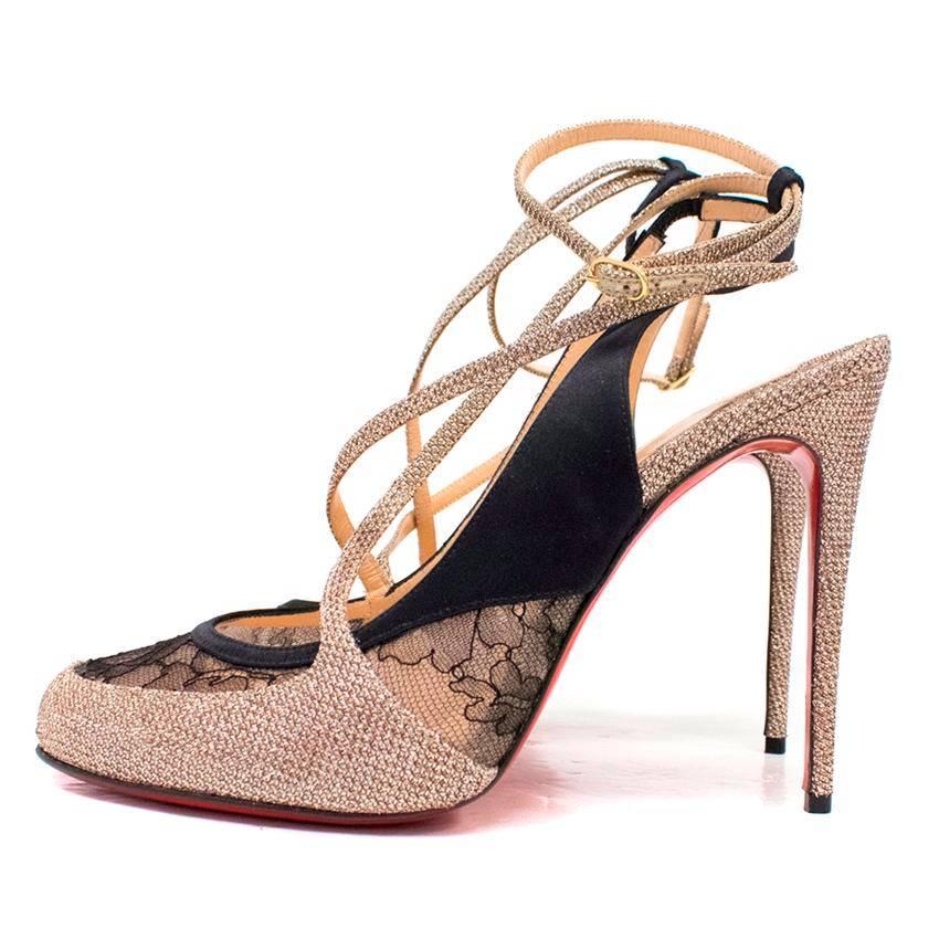Christian Louboutin high heeled sling back pumps with rounded toes featuring black lace, metallised gold thread around the toes and the heel and rimmed with black satin. Lined with nude leather and feature a classic red sole. 

There are minor signs