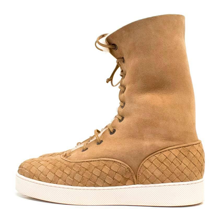 Bottega Veneta tan suede ankle boots with textured details at the front and back, leather laces fitted through metal eyelets and a zip on the side.
Lined with sherpa and feature a thick white rubber sole. 

There is minor wear to the sole, otherwise