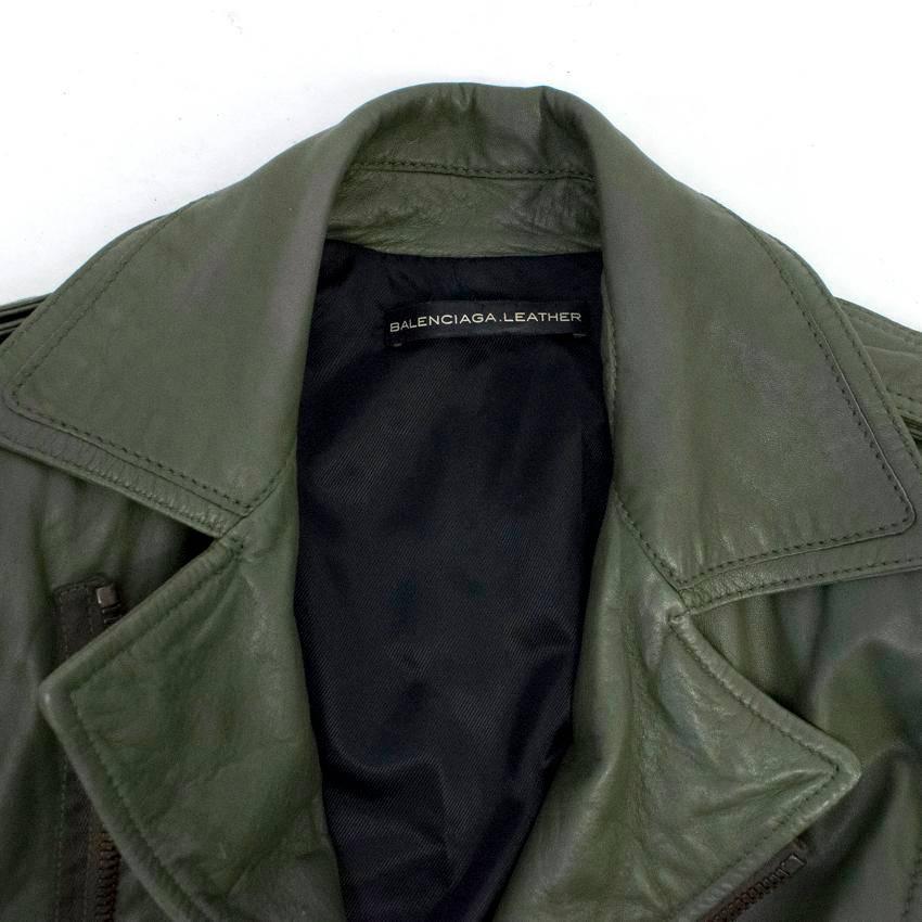 Balenciaga olive green lambskin leather jacket with padded shoulders, two zipped front pockets, a peak lapel and zips on the cuffs.
Fastens at the front with a copper toned metal zip. 
Fully lined with black rayon. 
Made in France. 

There are some