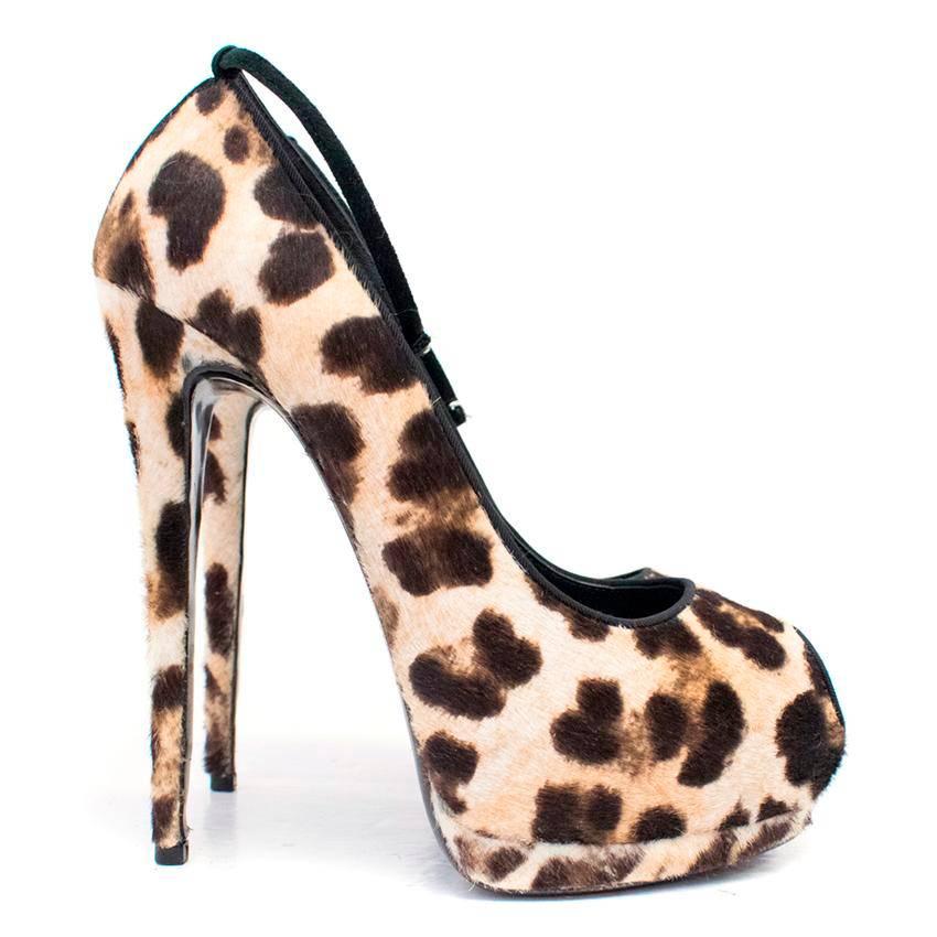 Giuseppe Zanotti high-heeled peep toe pumps on a platform with leopard printed pony hair rimmed with black silk and featuring a black suede ankle strap. 

There are minor signs of wear to the pony hair and normal wear to the soles, otherwise the