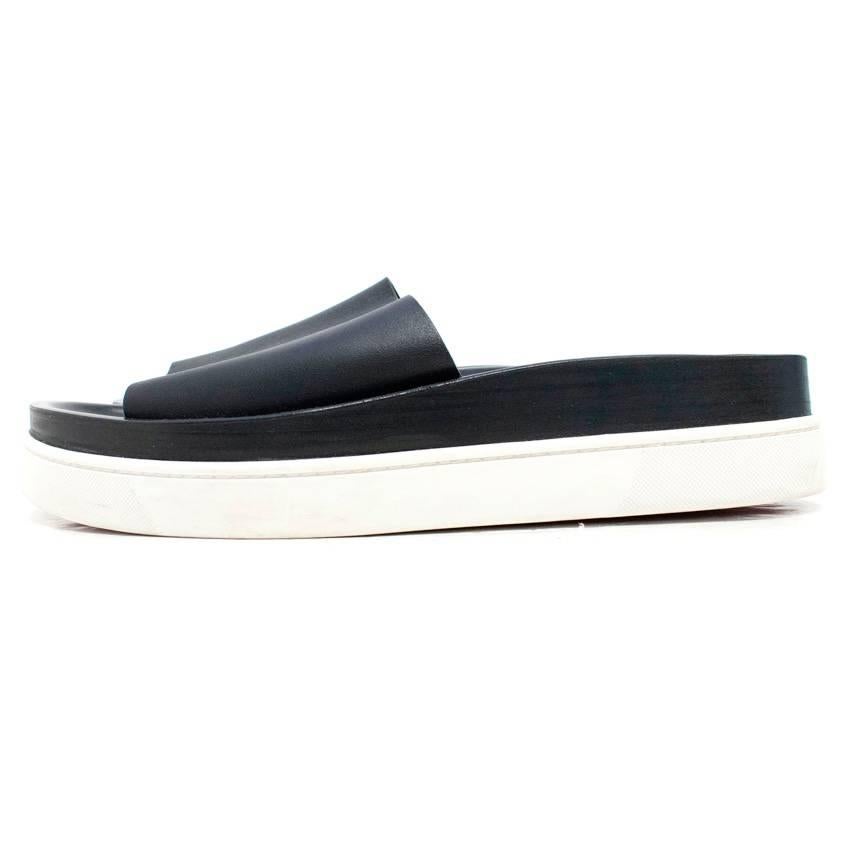 Christian Louboutin black leather sliders with a white thick rubber sole.

Some marks to the rubber sole. Condition: 9/10

Size IT: 45
Size UK: 11
Size US: 12

Measurements Approx:
Total Height: 5 cm
Sole Height: 2.5 cm
Toe to Heel: 31 cm 
Width:
