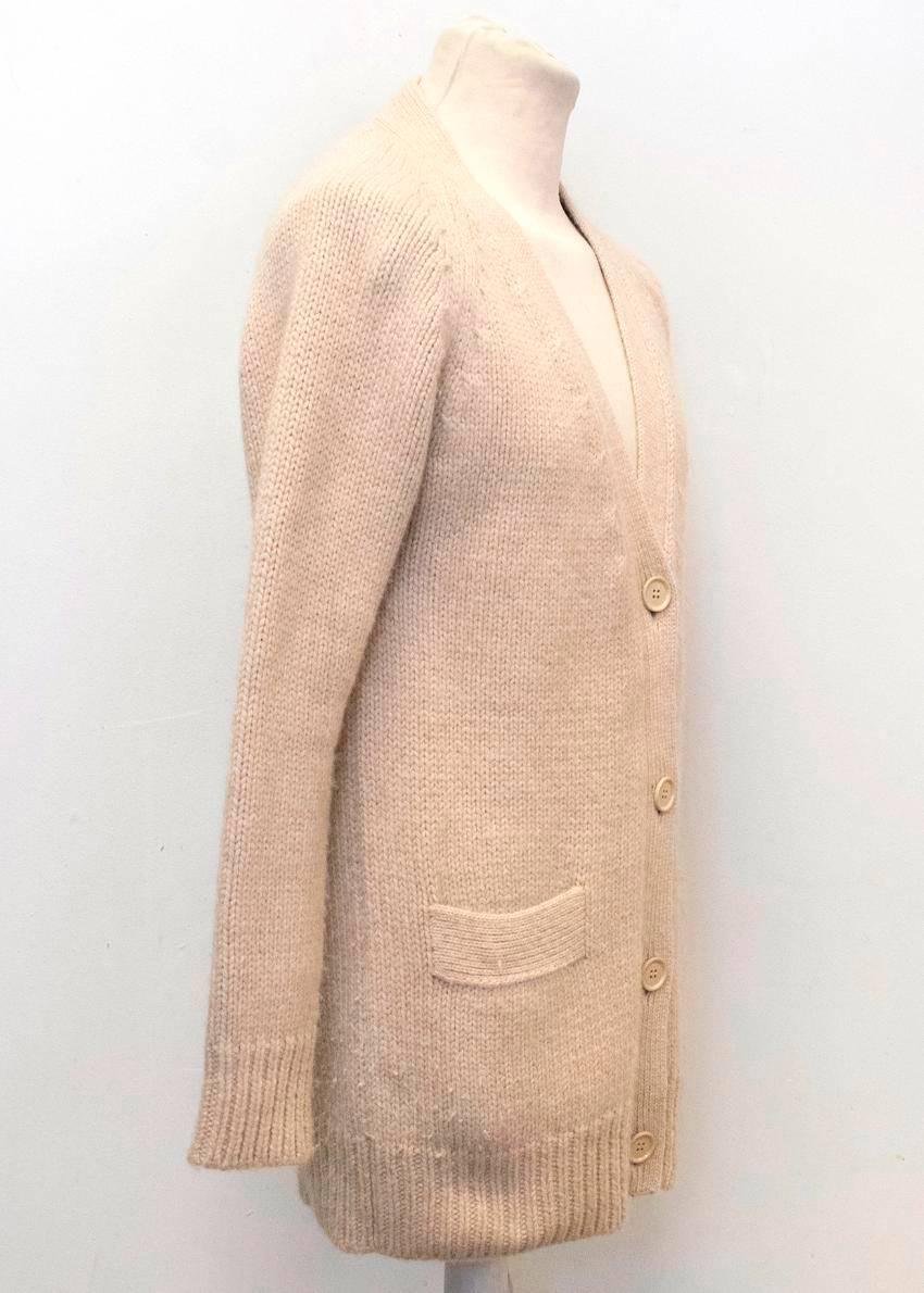 Prada mens beige chunky alpaca knit long sleeved cardigan with two front pockets and beige buttons at the front. 

Condition: 9.5/10 

Size: L
Size UK: 40
Size EU: 50

Measurements Approx.

length: 88 cm
sleeves: 64 cm
shoulders: 44cm
chest: 60cm