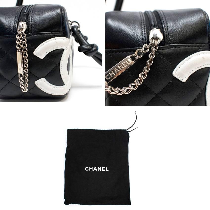 Chanel small black cambon bag with classic embossed white logo, bright pink canvas lining, a medium zipper pocket and small pocket.

Condition: 10/10

Measurements Approx:
Width: 24 cm
Height: 13 cm
Depth: 11 cm
Handle Length: 13 cm