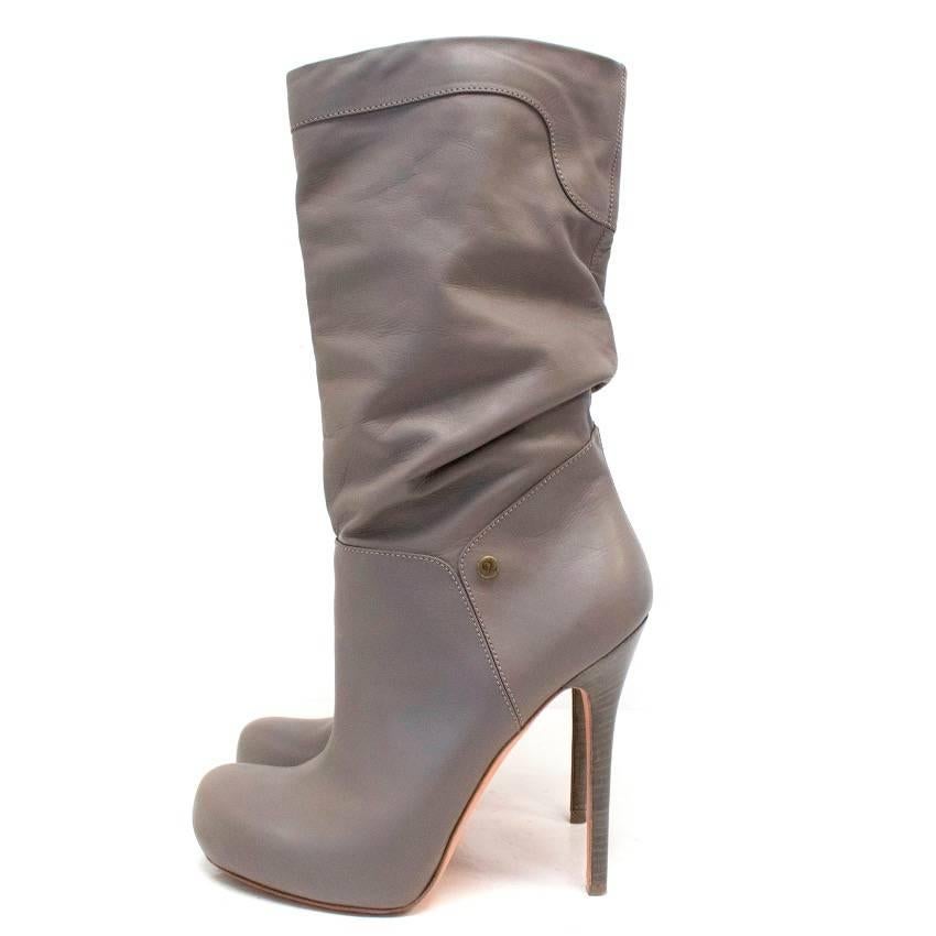 Alexander McQueen grey leather boots featuring a skinny wooden heel and slouched top. They also feature two gold buttons with the McQueen logo on the interior.

Made in Italy. Great Condition, 9.5/10.

SIZE 38/US 8.

Approximate measurements:
Total