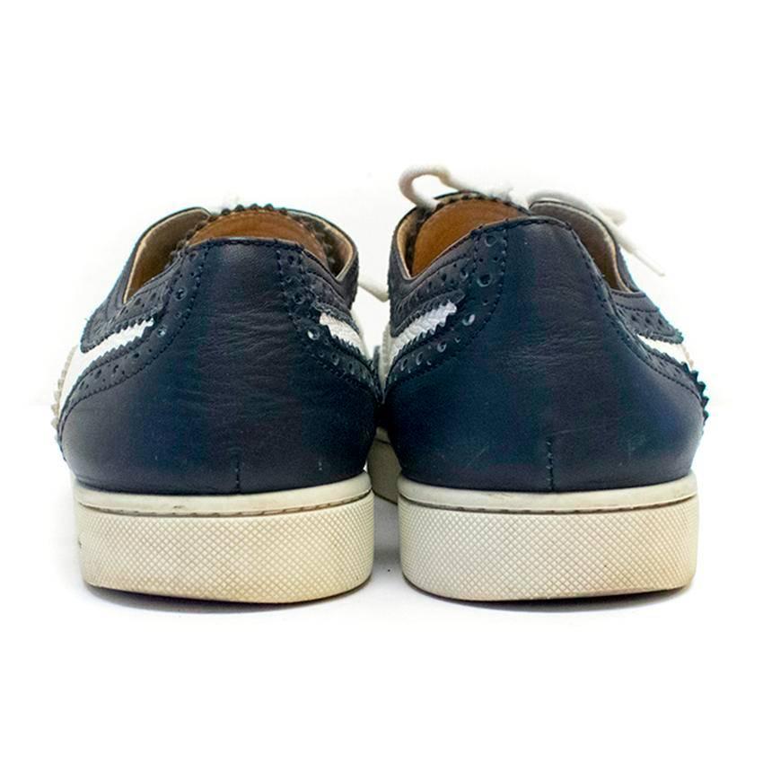 Christian Louboutin navy and white leather brogue trainers with lazer cut details, a white rubber sole and laces. 
Lined with nude leather. 

There are signs of wear to the exterior leather, normal wear to soles and lining.

Condition:8.5/10 

Size: