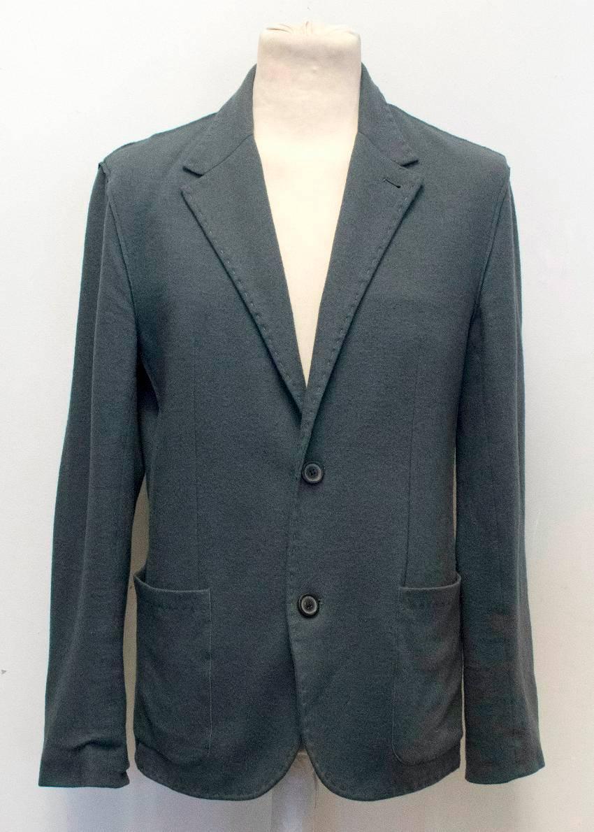 Lanvin men's grey wool relaxed fit casual blazer with a notch lapel, two front pockets and one interior pocket. Featuring four button cuffs and subtle decorative stitching. Fastens at the front with two buttons and is partially lined. 

A small seam
