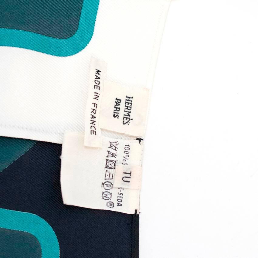 Hermes patterned silk, scarf wrap top with capped sleeves. Features a plunging neckline and fastens at the bottom with two concealed eyelet buttons. 

There is a minor mark at the front that will not be visible when worn.

Condition: 9/10

The size