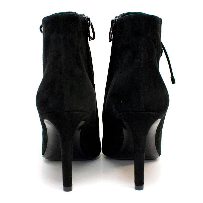 Balceniaga limited edition suede lace up stiletto ankle boots. The boots are sharply pointed and have black frosted metallic studs on the eyelets that the laces go around. The laces are black and have black suede aglets, and there is a zip on the
