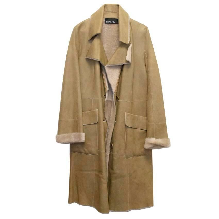 Marc Cain beige fur lined lambskin coat with belt.

Please note there are some very minor storage marks due to the nature of the leather, these are only noticeable on very close inspection and in some lights due to the nature of the fabric.