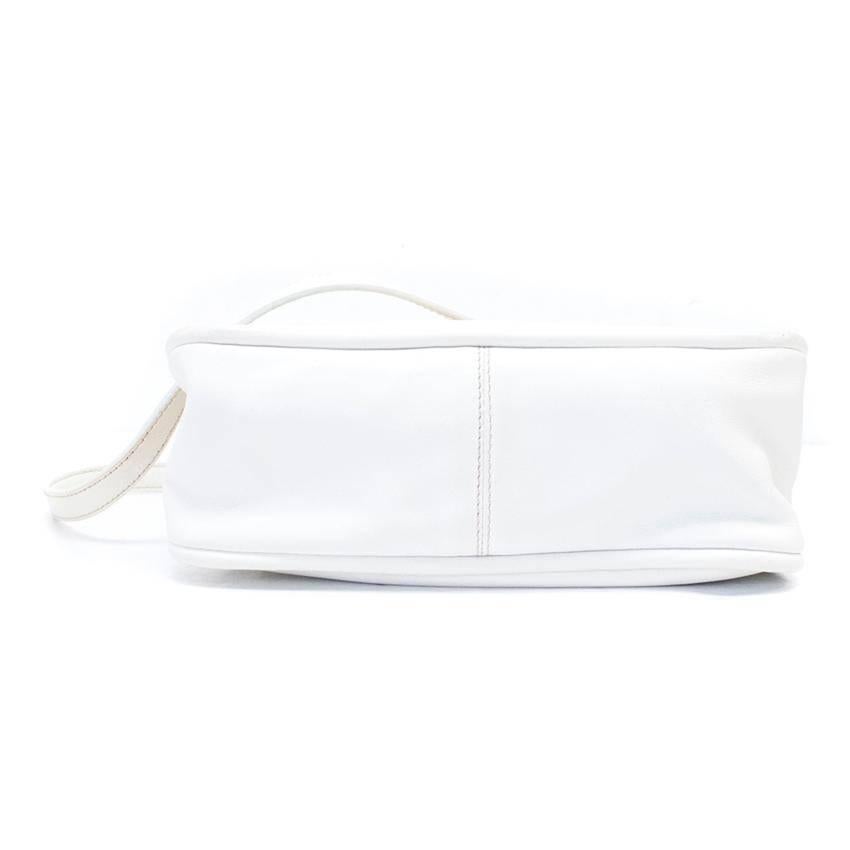 Miu Miu white leather, small cross body bag with gold hardware at the push button, lock closure and handles. It has a flap closure and one small interior zipper pocket.

Small marks to the front and sides. Small marks to hardware upon close