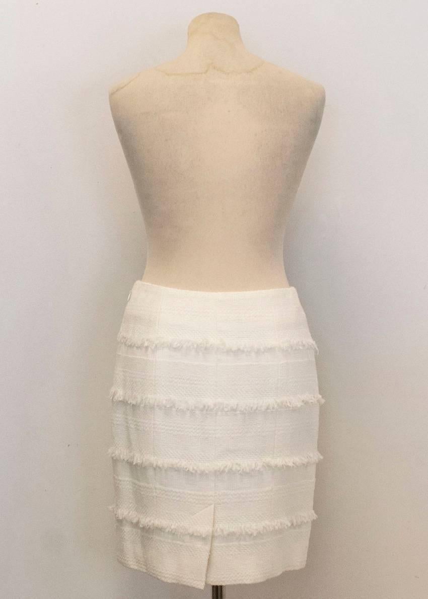 Chanel, cream tweed pencil skirt with frayed frill detail. Functioning zip at the side of the skirt and sliver Chanel hard wear logo on the front right hand side of the skirt. Panels of frill throughout the skirt. 

Made in france 

Condition:10/10