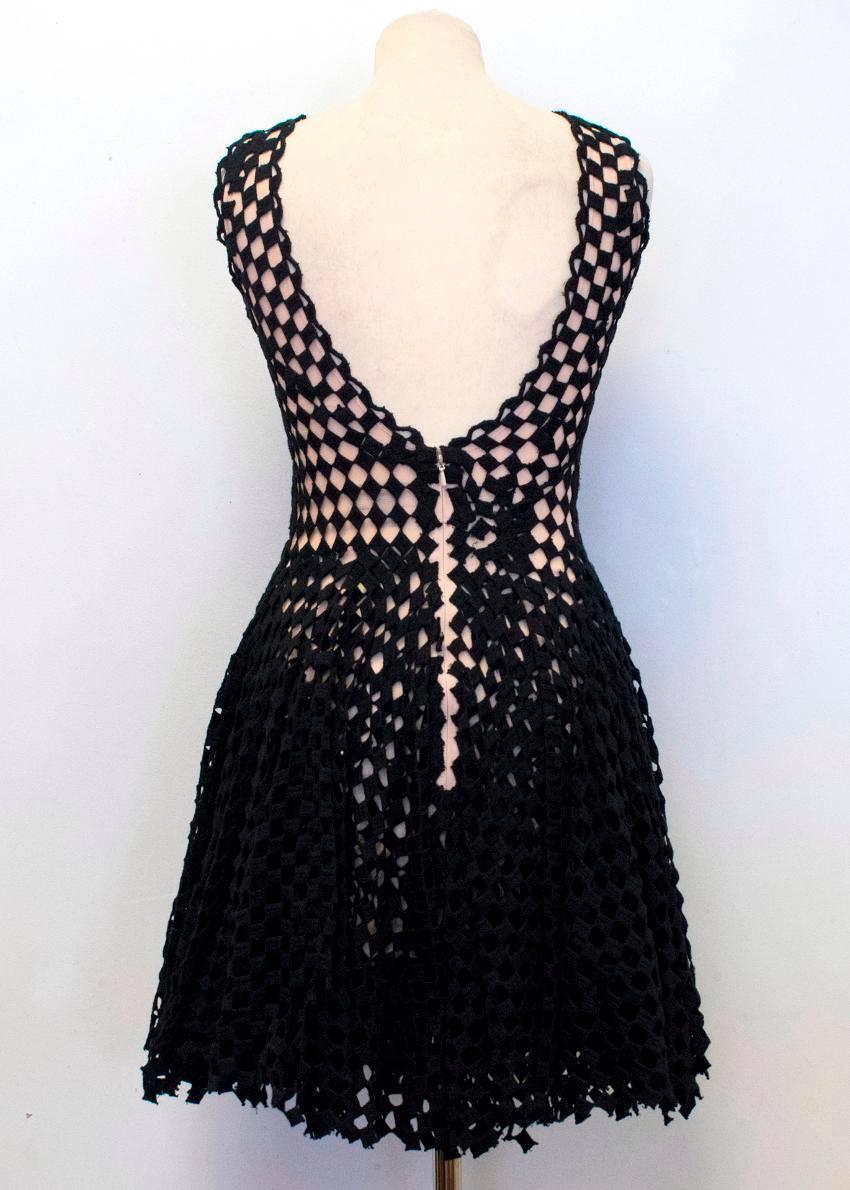 Jasmine di Milo black crotchet skater dress with a nude mesh underlay. 
Features cut out details throughout, a high scoop neckline and an open back. The dress fastens at the back with a concealed zip and a metal hook.

Condition: 10/10

The label