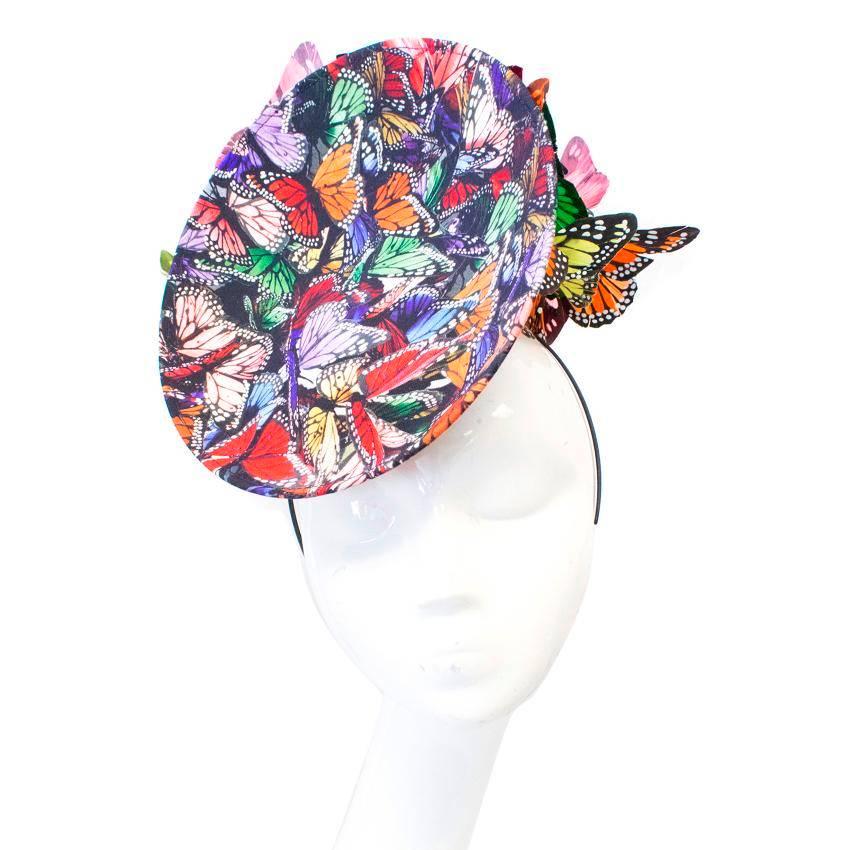Philip Treacy multicoloured butterfly fascinator hat with a disc detail at the front. The hat features a black headband that is concealed when worn and multicoloured feather butterflies at the back. 

Condition: 9.5/10 

Size: One Size

Measurements