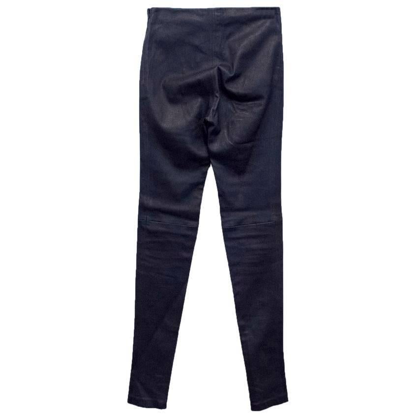 Balenciaga navy blue leather stretch trousers. The trousers are skinny fitting and high waisted. Feature zipped hems and fasten at the side with a concealed zip and a metal hook. 

There are very minor scartches on the pant leg that will not be