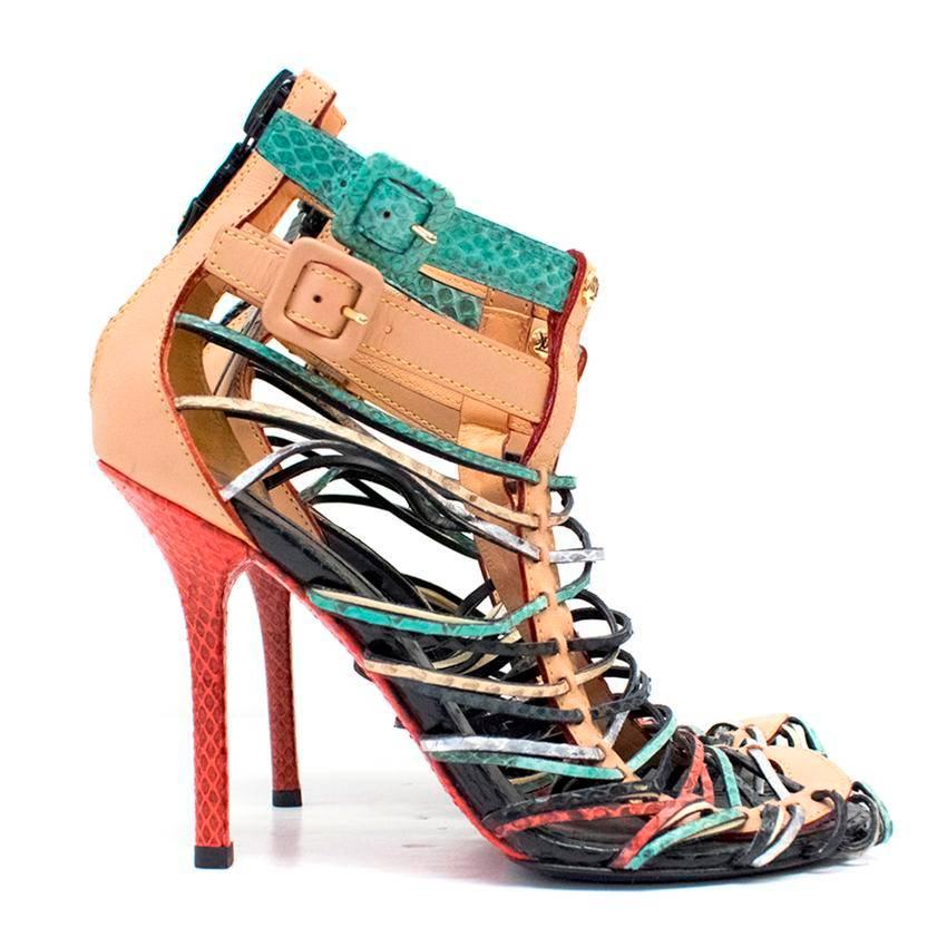 Louis Vuitton multicoloured snakeskin and leather strappy sandals. The shoes are high heeled and open toed and feature two ankle straps with covered gold toned buckles. 
Fasten at the back with an exposed black zip featuring a patent leather pull.