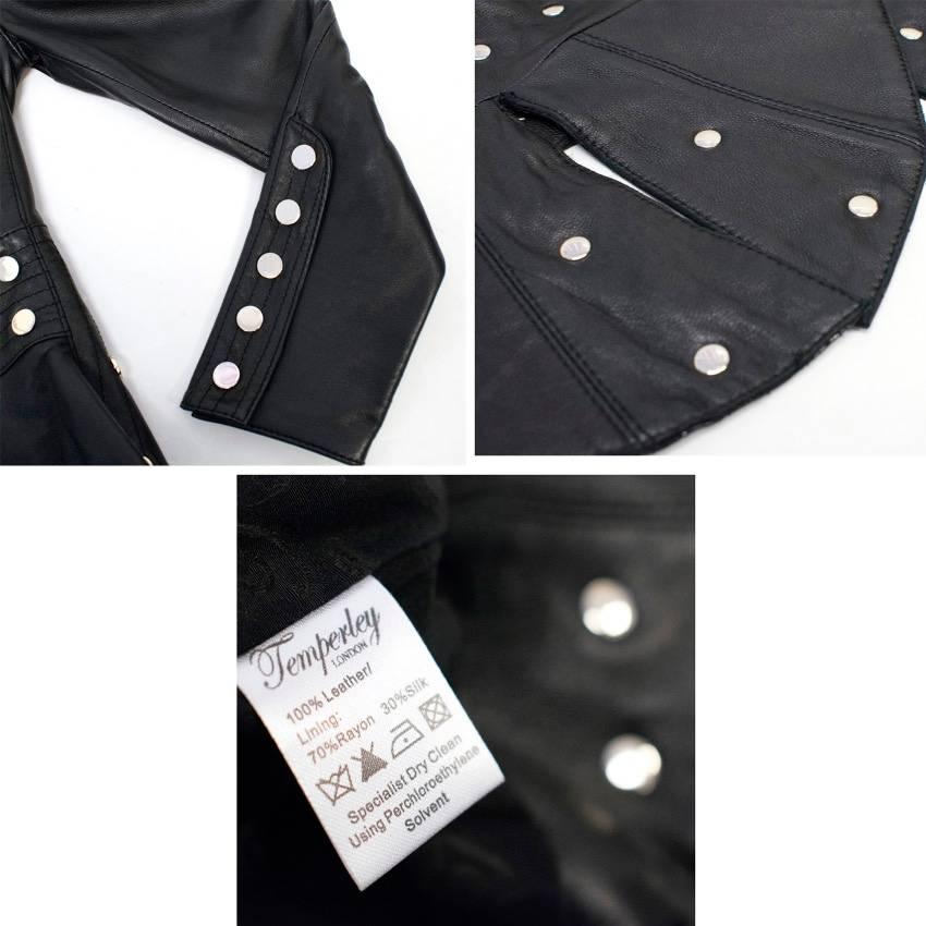 Temperately London black leather studded jacket. Features, mirrored stud detail panels, V neckline with collar, three front button closure, cinched waist effect and five button cuffs. This item is heavy weight. 

This item has minor scratches to
