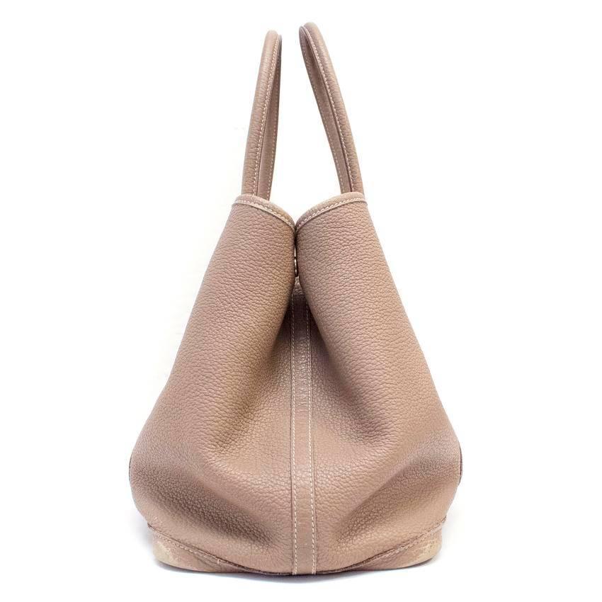 Hermes Garden Party 36 tote bag in taupe negonda leather, with chevron canvas lining. It features a silver and palladium plated 'Clou de Selle' snap closure.

Slight wear to the leather around the handles and on the base corners of the bag, and