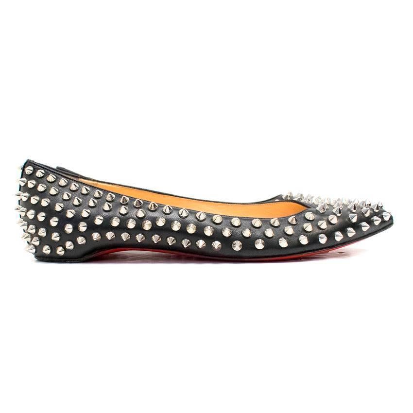 Christian Louboutin Pigalle black leather ballet flats with silver toned metal spikes. 
The flats feature pointed toes and nude leather lining. 
Also feature classic red soles. 
The shoes come in their original dust bag. 

There is normal wear to