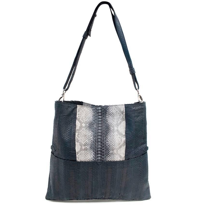 Adeline Germain navy python skin shoulder bag. Features, a removeable shoulder strap, concealed snap fastening and a interior zip pocket. Fully lined.

This bag is versatile to be a shoulder bag or folded over as a clutch bag.

Approx