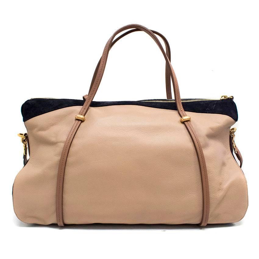 Nina Ricci Paris beige and blue shoulder bag with one large zipped compartment and 3 side pockets. Features two top handles, detachable shoulder strap, a luggage tag and gold hardware.

Approx measurements.
Approx:
Length -30cm 
Width -49cm
Depth