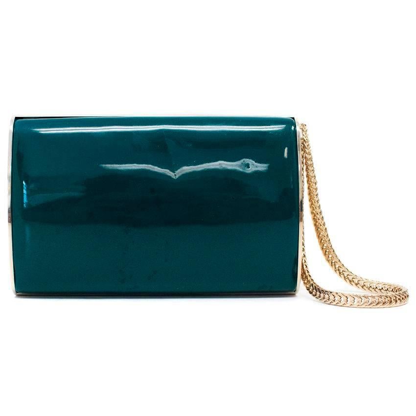 Jimmy Choo turquoise patent leather structured clutch with gold tone chain wristlet. Features gold lining. 

Approx measurements:
Length -10cm
Width -15cm 

Condition 9/10 - minor marks from storage and a scratch to the leather that is barely