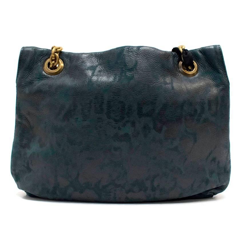 Lanvin deep teal leather bag with a faint black leopard print all over. Embellished with a brown stone twist clasp closure, brass hardware and chain handles. Handles feature wide black ribbon details, Lanvin coin fob, and black patent