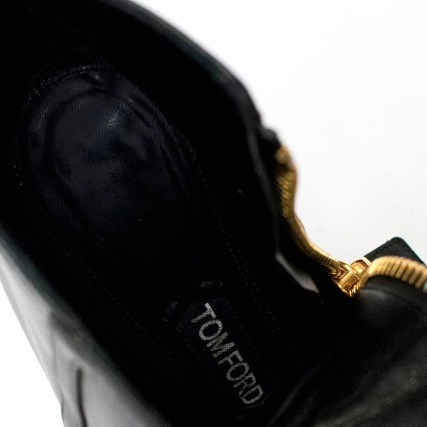 Tom Ford black ankle boots in a pointed toe stiletto heel style in soft leather featuring chunky gold zips. 

Condition: 9/10. Minor wear to soles.

Size EU: 39
Size UK: 6
Size US: 9

Measurements Approx:

width - 6.5cm
length - 22cm
heel height -