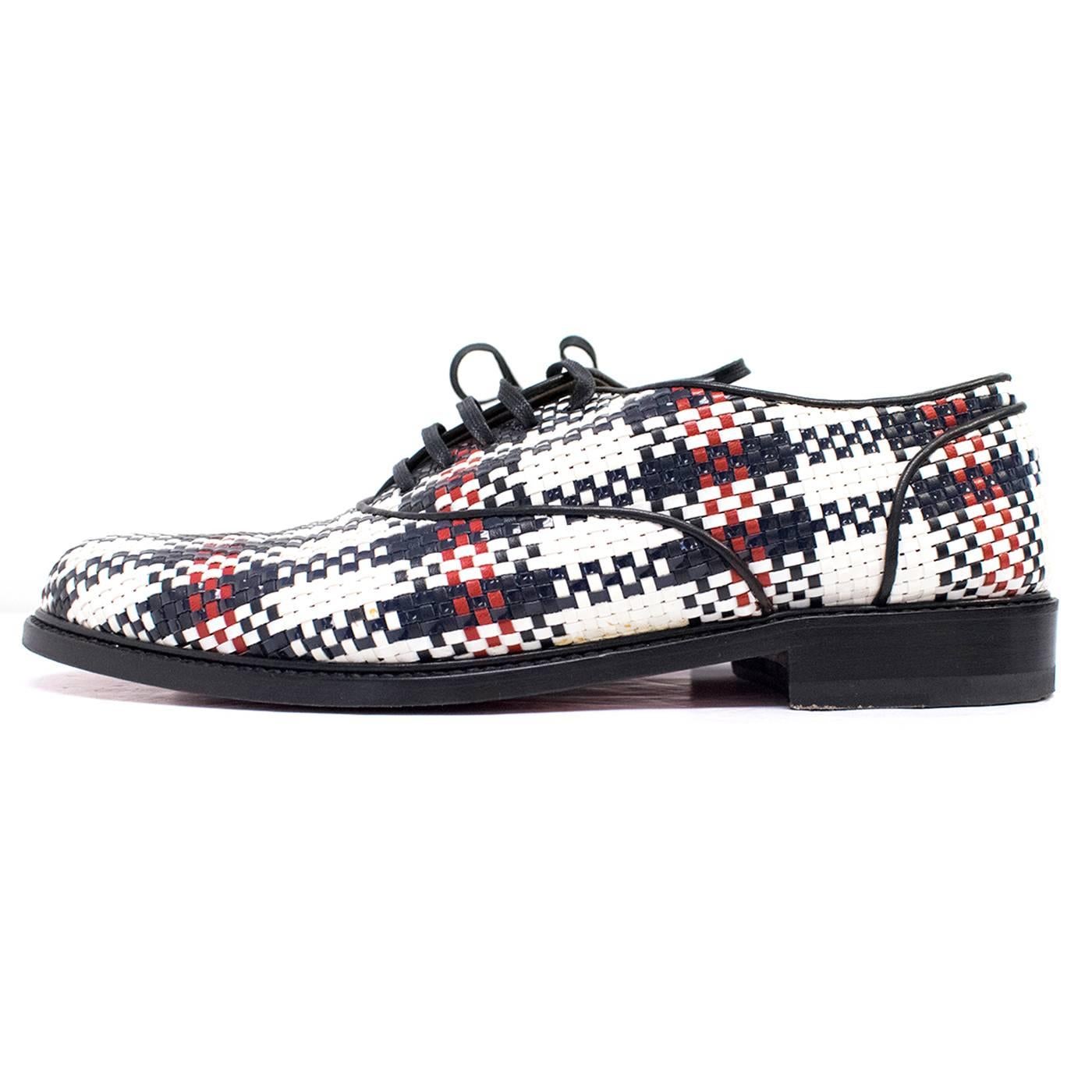 Christian Louboutin woven leather derby brogues. Features check woven leather pattern in tones of black, white and red, a round toe, lace up fronts, stacked black sole and signature Christian Louboutin red soles. 

There are signs of wear to the