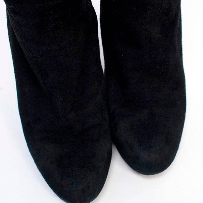 Jimmy Choo black suede over-the-knee boots in a soft sock-style fit featuring a round toe and stiletto heel. Fastened with a zip at the inside leg.

Condition: 9.5/10. Minor wear to soles.

Size IT: 39
Size UK: 6
Size US: 9

Measurements