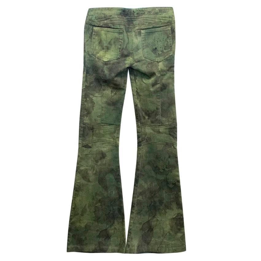 Balmain printed low rise flare jeans in tones of green. Features a zip fly with cross lace tie detail, two front side pockets, two rear pockets and panelled details. 

Knot in suede ribbon where it has been repaired. Condition: 9/10

The size label