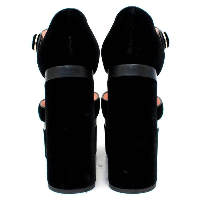Rochas black velvet platform pumps. Features block heel and button-fasten ankle strap with 'R' logo. 
Conditions Details : Some minor marks to heel and toe (see images 1 and 2). 

Condition - 9.5/10

Approx measurements: 
Height: 20 Cm 
Heel: 12 Cm